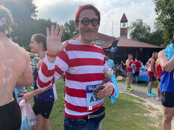 Juan Archila, seen here at Atlanta's Piedmont Park on Monday, July 4, 2022, has run the Atlanta Journal-Constitution Peachtree Road Race for 12 years and dressed up as Waldo for 11.