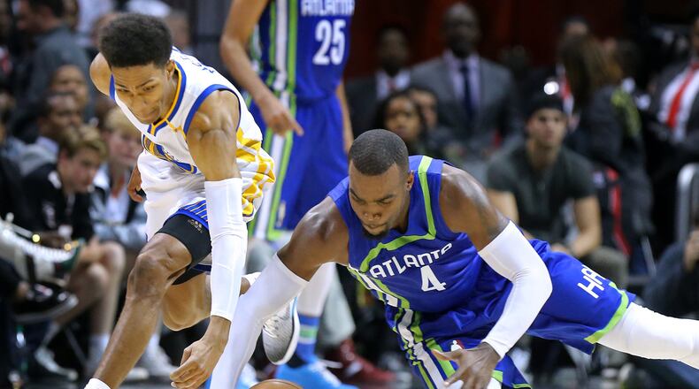 Hawks’ Paul Millsap and Warriors’ Patrick McCaw go after a loose ball during the second half in a NBA basketball game on Monday, March 6, 2017, in Atlanta. Curtis Compton/ccompton@ajc.com