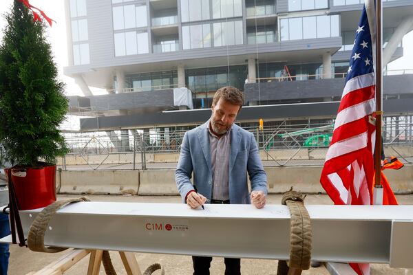 Brian McGowan, President of Centennial Yards, is seen signing the piece of the roof, marking a milestone in the construction of the Phoenix Hotel, which has now reached its highest point. The boutique hotel is one of six buildings currently under construction at Centennial Yards in Downtown Atlanta.
(Miguel Martinez / AJC)