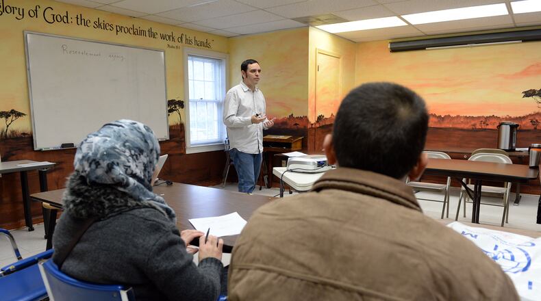 Syrian refugees Mohammad and his wife, Ebtesam listen to David Redd, senior case specialist, during an orientation session. KENT D. JOHNSON/ kdjohnson@ajc.com