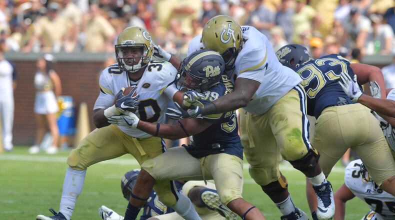 September 23, 2017 Atlanta - Georgia Tech running back KirVonte Benson (30) eludes a tackle by Pittsburgh linebacker Saleem Brightwell (39) in the first half at Bobby Dodd Stadium on Saturday, September 23, 2017. HYOSUB SHIN / HSHIN@AJC.COM