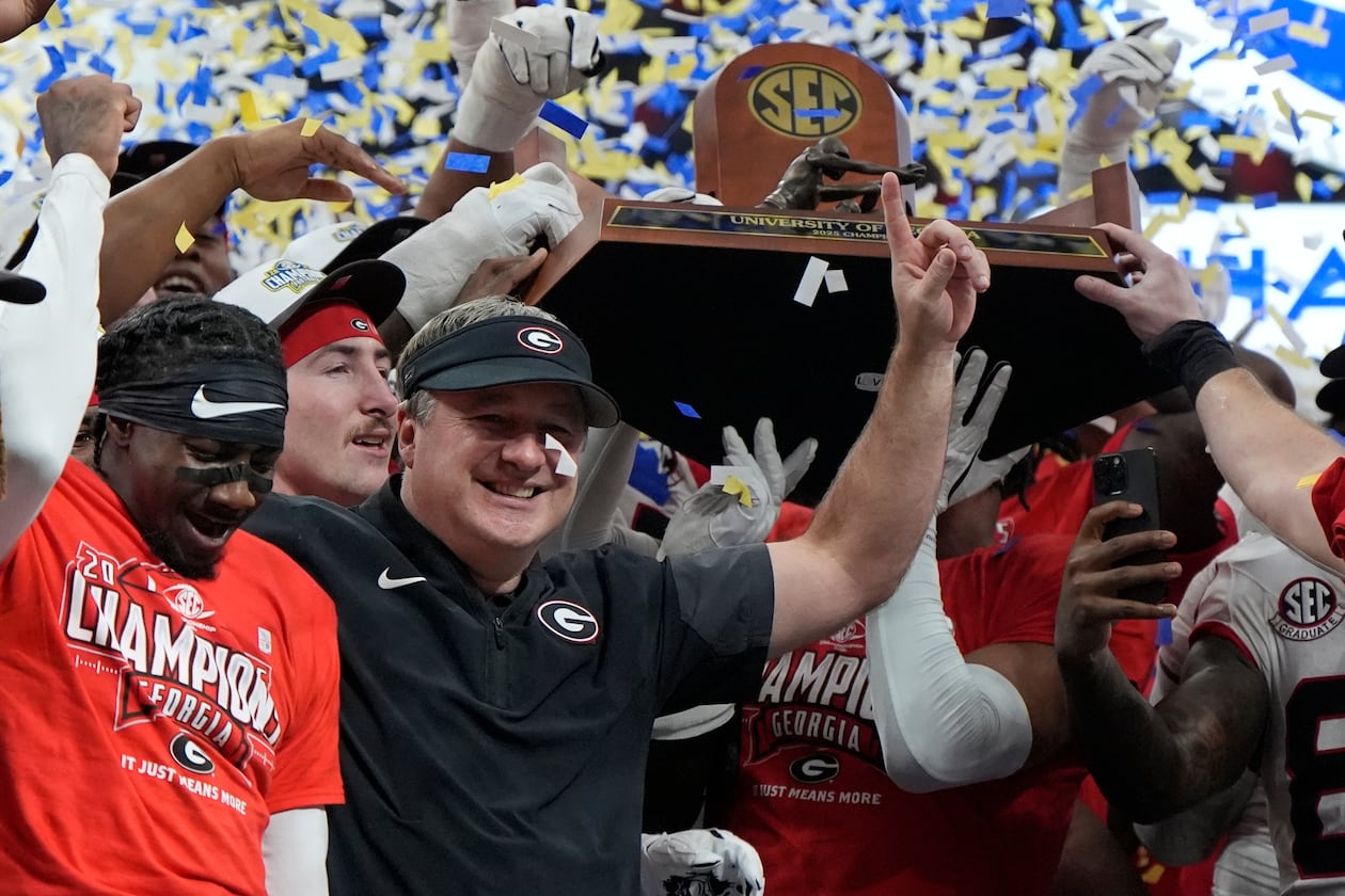 Georgia head coach Kirby Smart and team celebrate after a Southeastern Conference championship NCAA college football game against Alabama, Saturday, Dec. 6, 2025, in Atlanta. (Mike Stewart/AP)