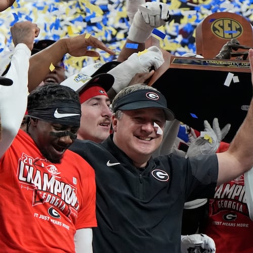 Georgia head coach Kirby Smart and team celebrate after a Southeastern Conference championship NCAA college football game against Alabama, Saturday, Dec. 6, 2025, in Atlanta. (AP Photo/Mike Stewart)