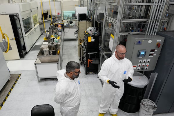 Tyler Gerczak, left, of Oak Ridge National Laboratory and Dan Brown, right, of TRISO-X a subsidiary of X-Energy, describe the method of manufacturing TRISO fuel in a laboratory Friday, June 27, 2025, in Oak Ridge, Tenn. (AP Photo/George Walker IV)