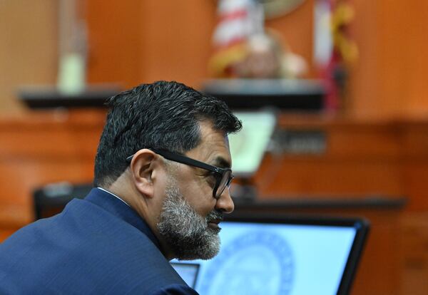 Manny Arora, attorney for Sumanth and Anindita Rao, looks toward his clients during a hearing at DeKalb County Courthouse in April 2026. (Hyosub Shin/AJC)