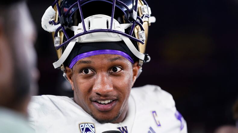 Washington quarterback Michael Penix Jr. is interviewed after the team's win over Southern California in an NCAA college football game, Saturday, Nov. 4, 2023, in Los Angeles. (AP Photo/Ryan Sun)