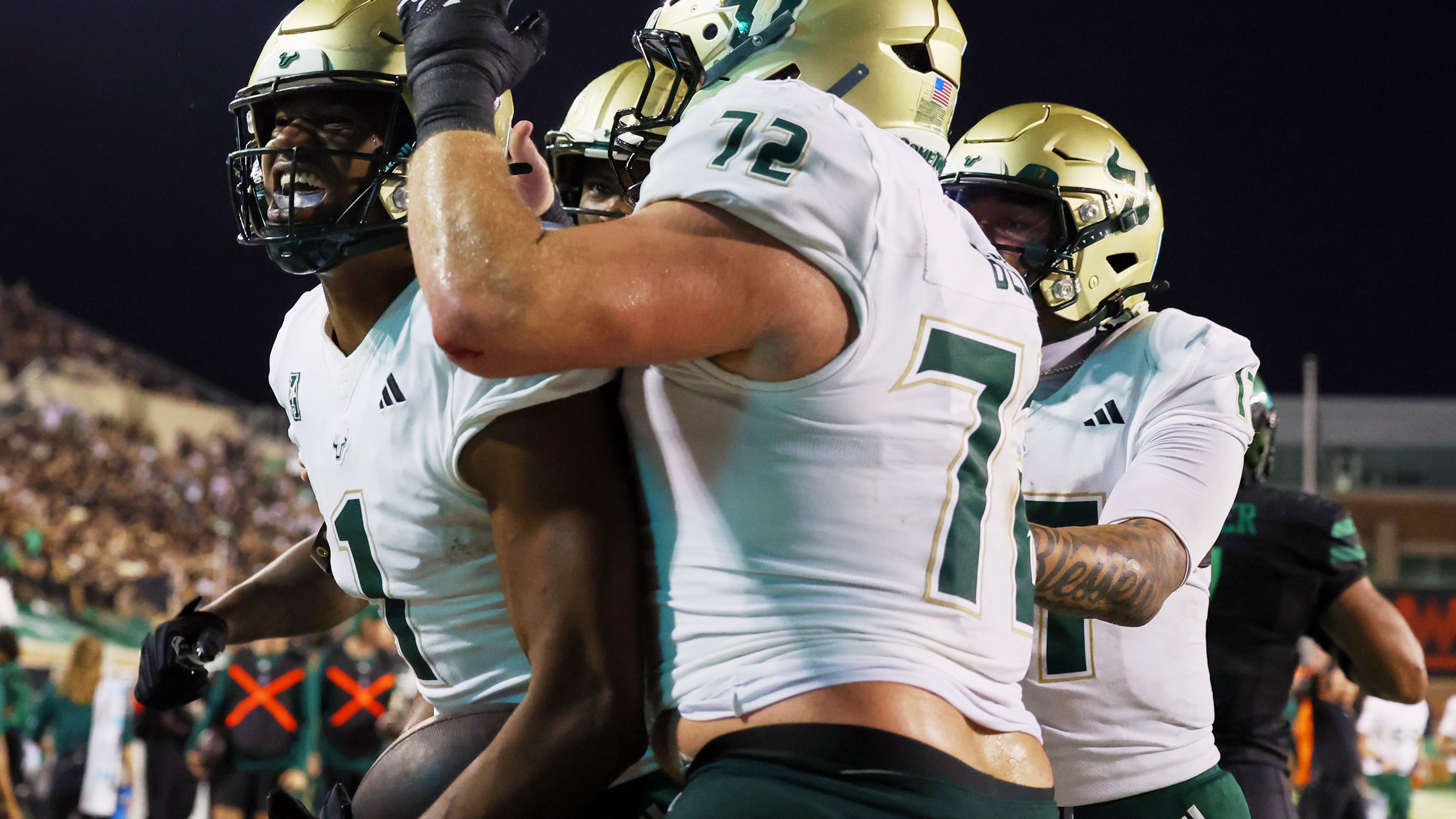 South Florida tight end Johnathan Echols celebrates a touchdown with Cole Best (72) and quarterback Byrum Brown (17) against North Texas in an NCAA college football game Friday, Oct. 10, 2025, in Denton, Texas. (AP Photo/Richard W. Rodriguez)