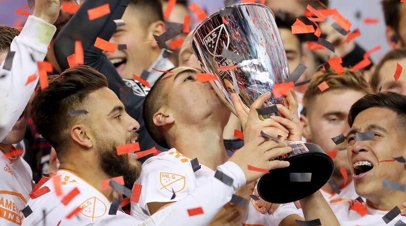 Miguel Almiron of Atlanta United FC kisses the conference trophy after they won the Eastern Conference Finals Leg 2 match against the New York Red Bulls at Red Bull Arena on November 29, 2018 in Harrison, New Jersey. (Photo by Elsa/Getty Images)