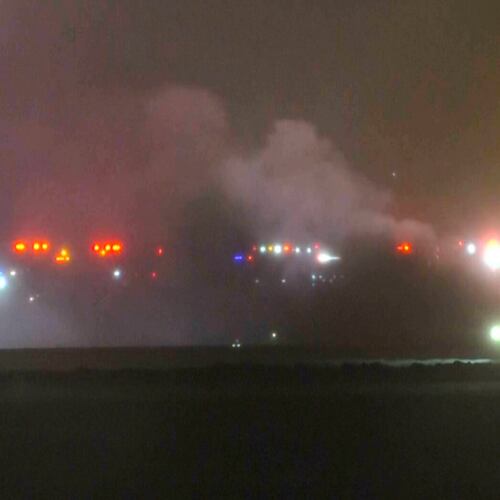 This image taken from video provided by WABI television, emergency services work on a scene of the Bombardier Challenger 600 crash at the Bangor Airport in Maine, late Sunday, Jan. 25, 2026. (WABI via AP)