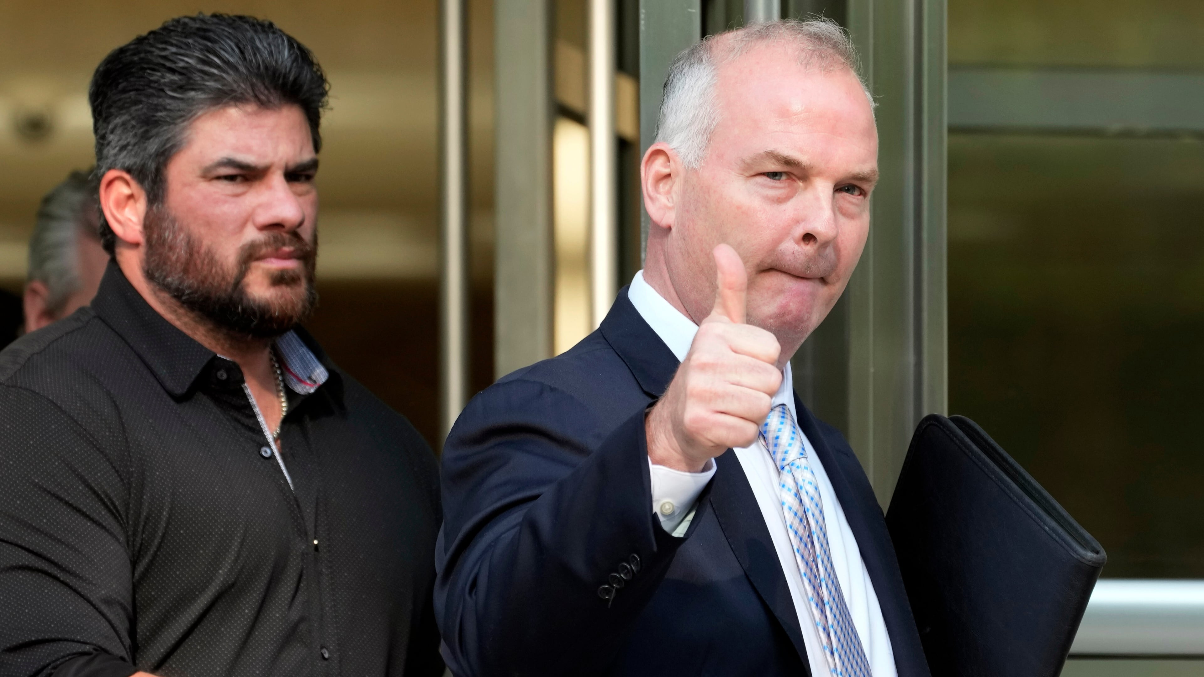 FILE - Michael McMahon, right, gives photographers a thumbs up as he leaves federal court, May 31, 2023, in the Brooklyn borough of New York. (AP Photo/Mary Altaffer, File)