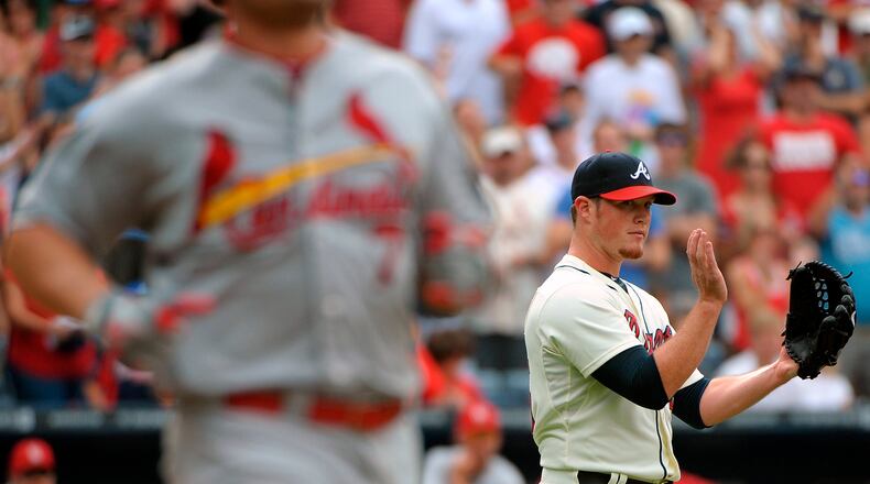 Braves closing pitcher Craig Kimbrel, right, reacts to the St. Louis Cardinals' final out during the ninth inning of a baseball game at Turner Field, Saturday, July 27, 2013, in Atlanta. The Braves won 2-0.