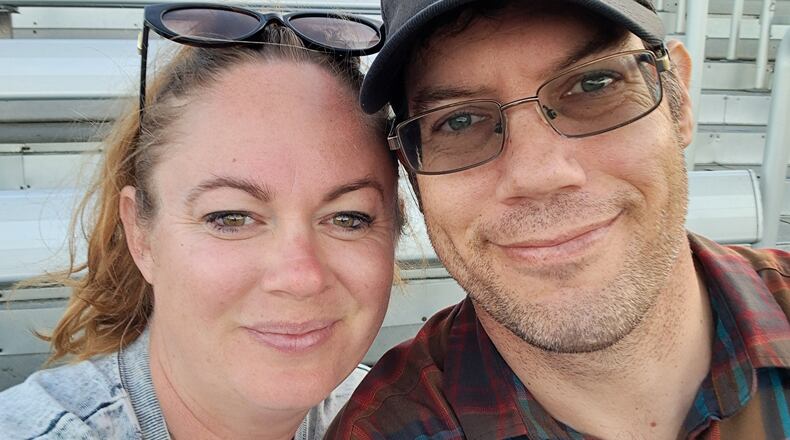This undated photo provided by Rebecca Rischar on Wednesday, June 17, 2026, shows her, left, posing for a photo with her husband Christopher Rischar. (Rebecca Rischar via AP)