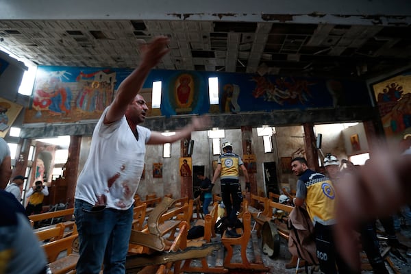 A Syrian man reacts inside Mar Elias church where a suicide bomber detonated himself in Dweil'a in the outskirts of Damascus, Syria, Sunday June 22, 2025. (AP Photo/Omar Sanadiki)