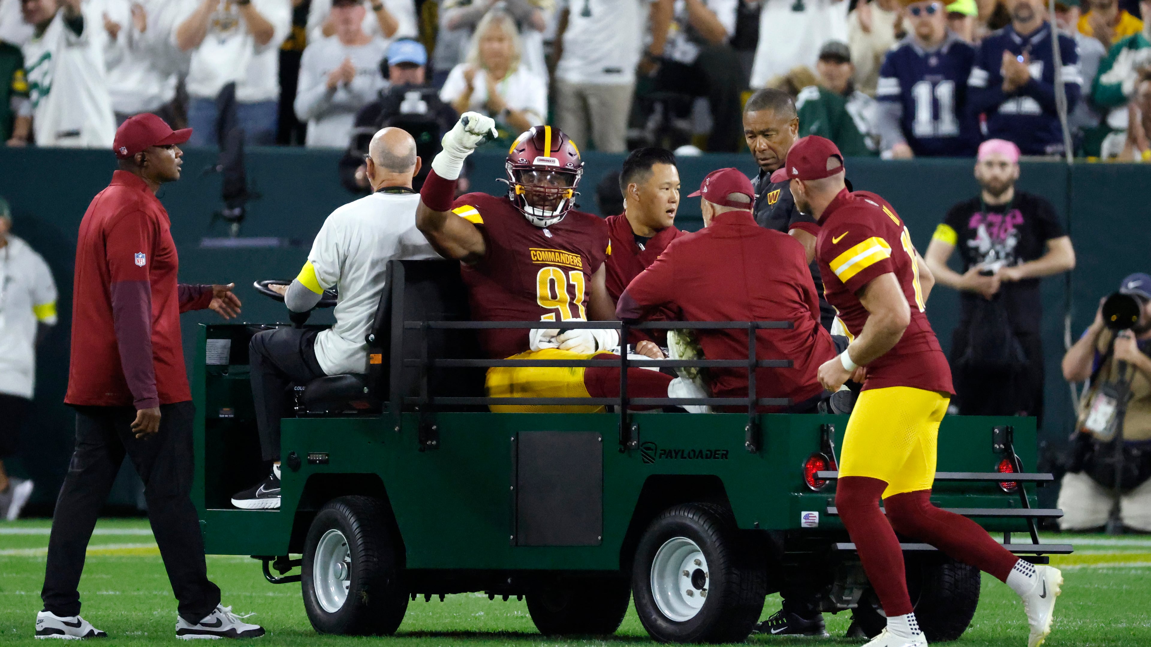 Washington Commanders defensive end Deatrich Wise (91) is taken off on a cart after being injured during the first half of an NFL football game against the Green Bay Packers Thursday, Sept. 11, 2025, in Green Bay, Wis. (AP Photo/Mike Roemer)