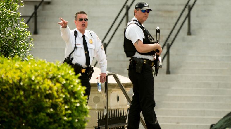A Secret Service agent orders people into buildings near the entrance to the West Wing of the White House in Washington, Friday, May 20, 2016, after the White House was placed on security alert after shooting on street outside. (AP Photo/Andrew Harnik)