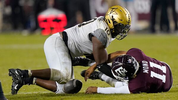 Texas A&M quarterback Kellen Mond (11) fumbles the ball on fourth down as he is hit by Vanderbilt's Dayo Odeyingbo (10) during the second half Saturday, Sept. 26, 2020, in College Station, Texas. Texas A&M won 17-12. (David J. Phillip/AP)