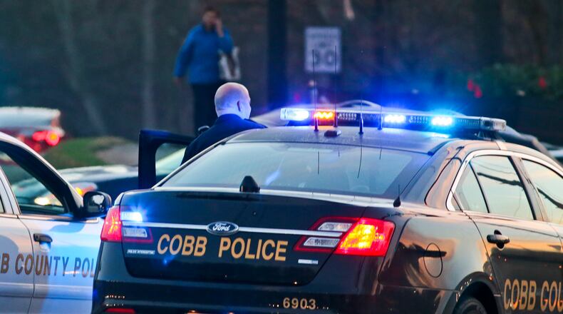 Cobb County police officers at a crime scene on March 12, 2015. JOHN SPINK/ JSPINK@AJC.COM/ 2015 ajc file photo