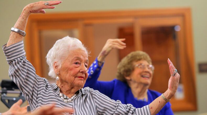 Dolores Combs, 91, follows along with ballet instructor Vanessa Woods, of Vitality Ballet, during class at The Willows at Brooking Park in Chesterfield on Wednesday, Aug. 2, 2017. Vitality Ballet brings dance to older adults using modified ballet steps that can be done entirely from a seated position. (Cristina M. Fletes/St. Louis Post-Dispatch/TNS)