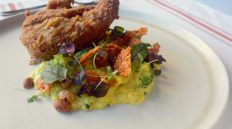 At White Oak Kitchen and Cocktails, the rice porridge that accompanies fried chicken holds West African influences such as pickled broccoli stems and smoked peanuts.