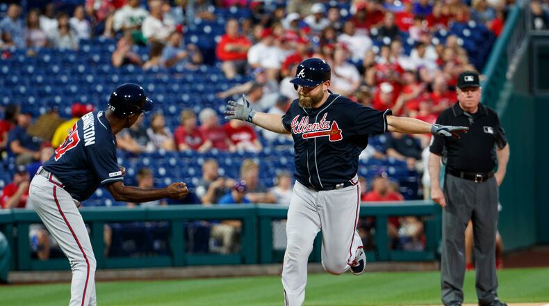 Atlanta Braves' Brian McCann, right, celebrates his home run with third base coach Ron Washington, left, during the fifth inning of a baseball game against the Philadelphia Phillies, Friday, July 26, 2019, in Philadelphia. (AP Photo/Chris Szagola)