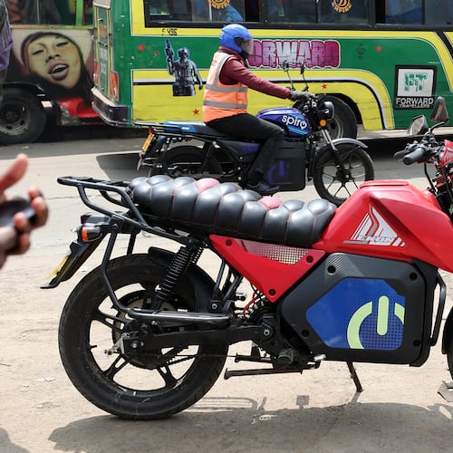 A man rides an electric Spiro motorcycle in Nairobi, Kenya, Tuesday, Feb. 24, 2026. (AP Photo/Henry Naminde)