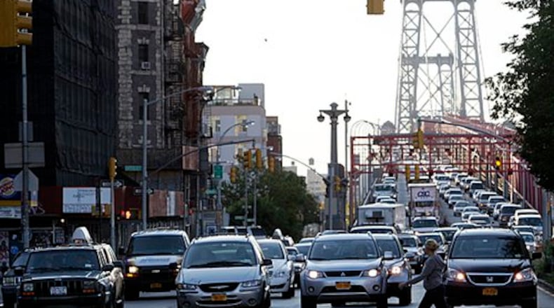 Morning rush hour traffic makes its way into Manhattan over the Brooklyn Bridge in New York. Photo via AP.