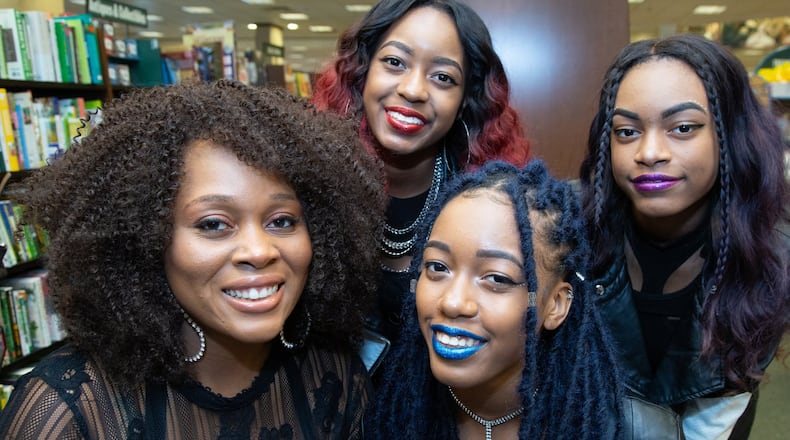 Portrait of Atlantan Ni’cola Mitchell (from left) with Amina Ochoa and her sisters Kelena & Micah at the Barnes & Noble Perimeter store in Dunwoody. Mitchell founded Girls Who Brunch, an event-like tour that gives at-risk girls mentoring opportunities and empowers them to flourish as they move into adulthood. (Photo by Phil Skinner)