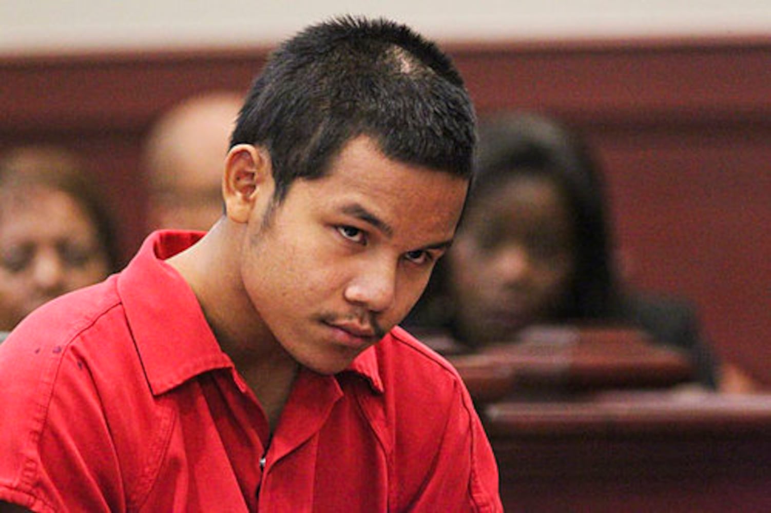 Teen in court, accused of killing cop