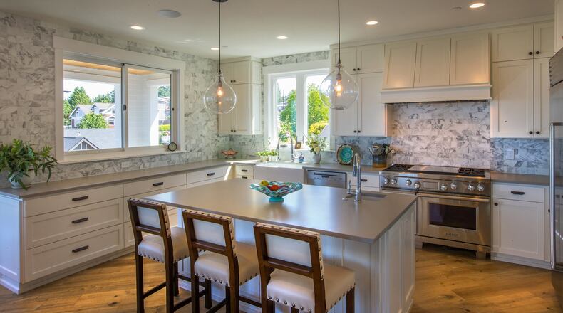 Beth Sanger says she chose quartz for the countertops and patterned walls in the bright, open kitchen, “because I really wanted a natural material with functionality.” She worked with Tammara Stroud Design on the interiors. “We love using a lot of color,” Beth says. “I wanted a pretty colorful background; I collect colorful glassware. I was using all my favorite things.” (Mike Siegel/Seattle Times/TNS)