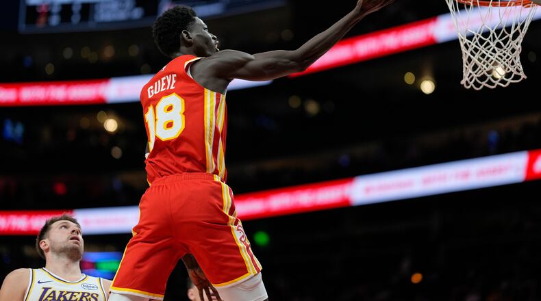 Atlanta Hawks forward Mouhamed Gueye (18) shoots against Los Angeles Lakers guard Luka Doncic (77) during the first half of an NBA basketball game, Saturday, Nov. 8, 2025, in Atlanta. (AP Photo/Mike Stewart)