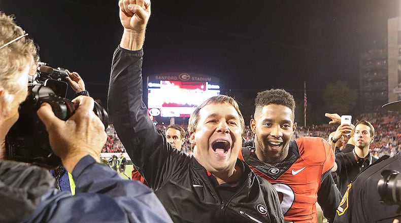 Georgia head coach Kirby Smart and defensive back Maurice Smith, who intercepted a pass and returned it for a touchdown, celebrate a 13-7 victory over Auburn last season in Athens. Curtis Compton/ccompton@ajc.com