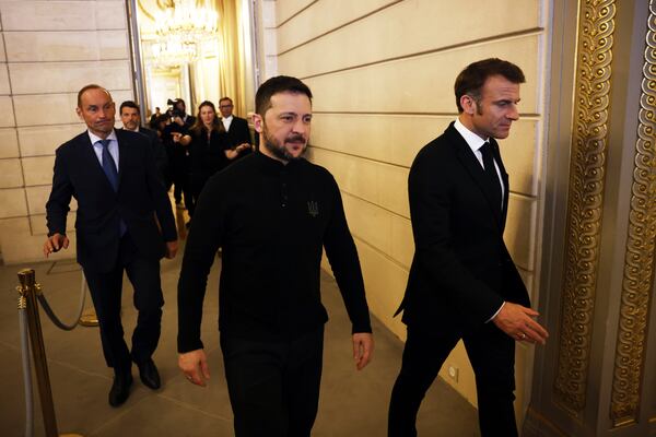 Ukrainian President Volodymyr Zelenskyy, left, and French President Emmanuel Macron arrive for a joint press conference following a bilateral meeting at the Elysee Palace in Paris, Wednesday, March 26, 2025. (Yoan Valat, Pool via AP)
