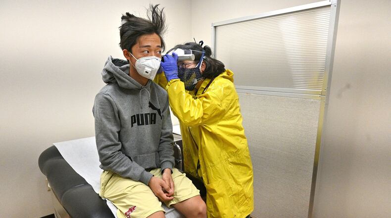 AJC visual journalist Hyosub Shin’s son, Jay, is examined recently after falling ill with flu-like symptoms. Shin has been self-quarantining since then and misses covering news of the ongoing pandemic. (Photo: Hyosub Shin / Hyosub.Shin@ajc.com)