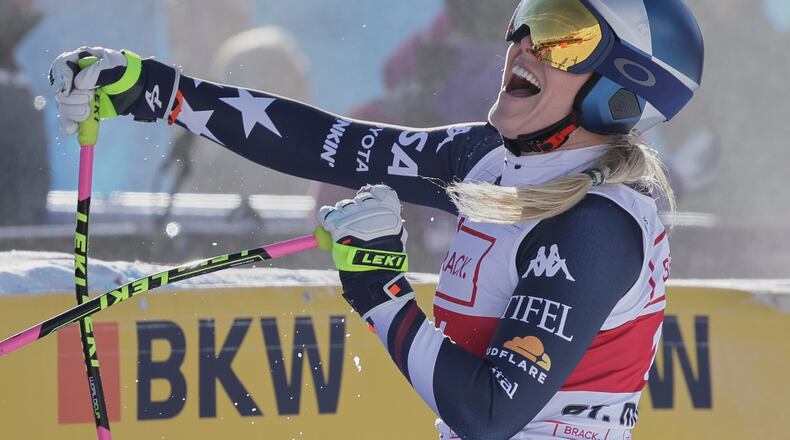 United States' Lindsey Vonn celebrates at the finish area of an alpine ski, women's World Cup downhill in St. Moritz, Switzerland, Friday Dec.12, 2025. (AP Photo/Luciano Bisi)