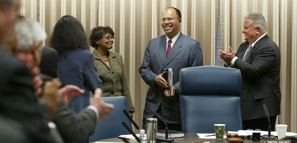 Erroll Davis, center, is introduced as the new chancellor of the University System of Georgia as his wife, Elaine, left, and regent J. Timothy Shelnut, right, look on. (John Spink/AJC 2005) 