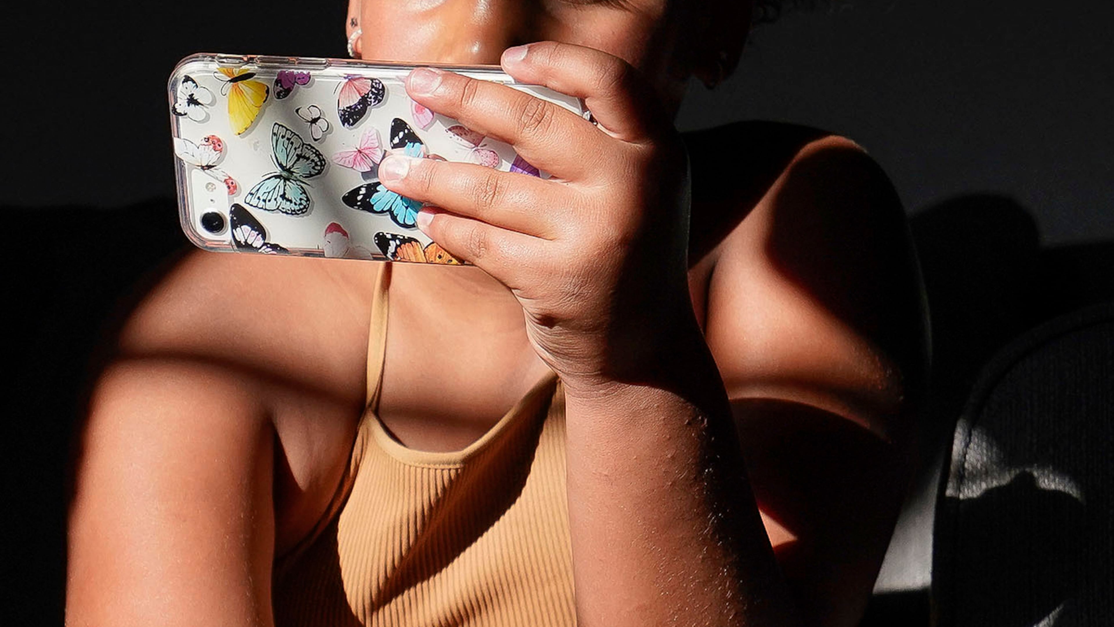 A girl uses her smartphone at home in Arizona on Friday, June 16, 2023. (AP Photo/Darryl Webb)