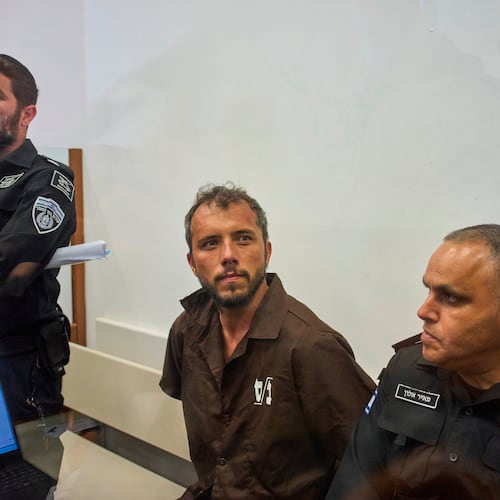 Brazilian activist Thiago Ávila, center, a member of the Global Sumud Flotilla, is escorted by prison service guards to a hearing at the District Court in Ashkelon, Israel, on Sunday, May 3, 2026. (AP Photo/Ohad Zwigenberg)