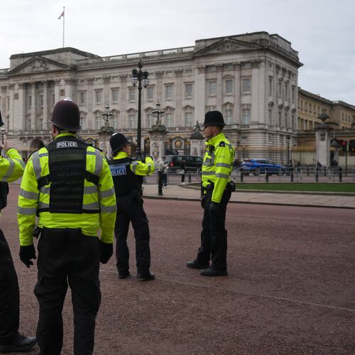 Police officers stand in front of Buckingham Palace in London, Friday, Feb. 20, 2026 after Andrew Mountbatten-Windsor was arrested and held for hours by British police on suspicion of misconduct in public office related to his links to Jeffrey Epstein.(AP Photo/Kin Cheung)