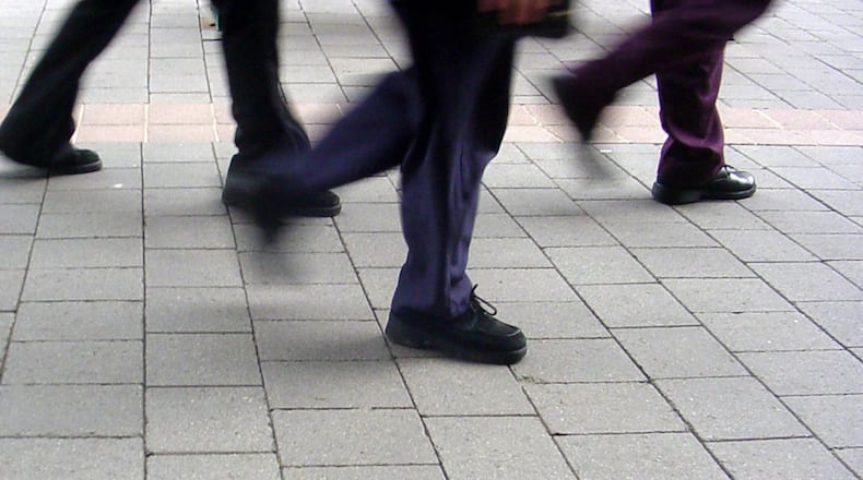 File photo of people walking on the sidewalk.