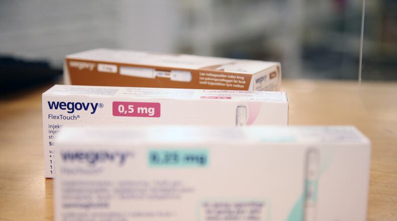 Various packages of the weight-loss drug 'Wegovy' from the pharmaceutical company Novo Nordisk lie on the sales counter in a Danish pharmacy. (Steffen Trumpf/dpa via ZUMA Press/TNS)