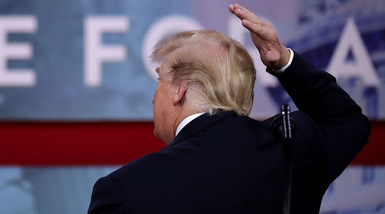 U.S. President Donald Trump jokes about covering his bald spot while addressing the Conservative Political Action Conference.
 (Photo by Chip Somodevilla/Getty Images)