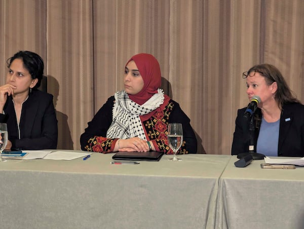 Mapheze Saleh, center, wife of arrested and detained Georgetown University scholar Badar Khan Suri, listens during a press conference about her husband's release following his hearing at Federal District Court for the Eastern District of Virginia, in Alexandria, Va., Thursday, May 14, 2025 (AP Photo/Nathan Ellgren)