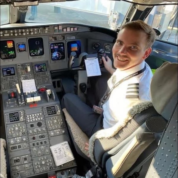 Sam Lilley (shown in a PSA Airlines cockpit in 2023) decided to quit marketing and become a pilot. He was just about to be made captain when an Army helicopter crashed into his plane. PSA Airlines made him captain honorarily after his death. (Courtesy of the Lilley Family)