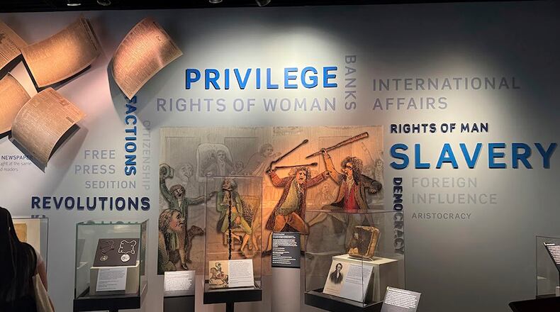 FILE - A display in the "Great Debate" section of a democracy exhibit at the National Museum of American History, seen Aug. 26, 2025, in Washington, reflects some of the issues the nation grapples with. (AP Photo/Calvin Woodward, File)