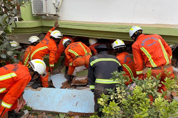 Myanmar rescuers search for survivors of Friday's earthquake beneath a damaged building in Naypyitaw, Myanmar, Saturday, March 29, 2025. (AP Photo/Aung Shine Oo)
