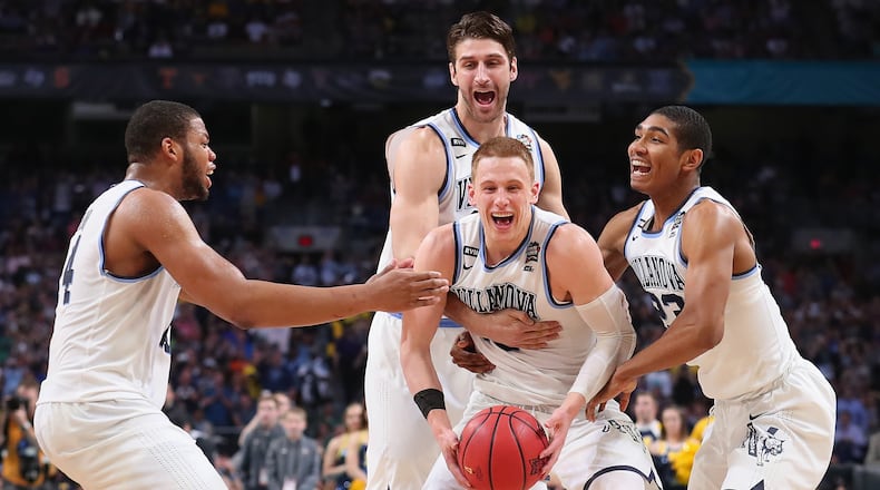 Donte DiVincenzo #10 of the Villanova Wildcats celebrates with teammates after defeating the Michigan Wolverines during the 2018 NCAA Men's Final Four National Championship game at the Alamodome on April 2, 2018 in San Antonio, Texas. Villanova defeated Michigan 79-62.  (Photo by Tom Pennington/Getty Images)