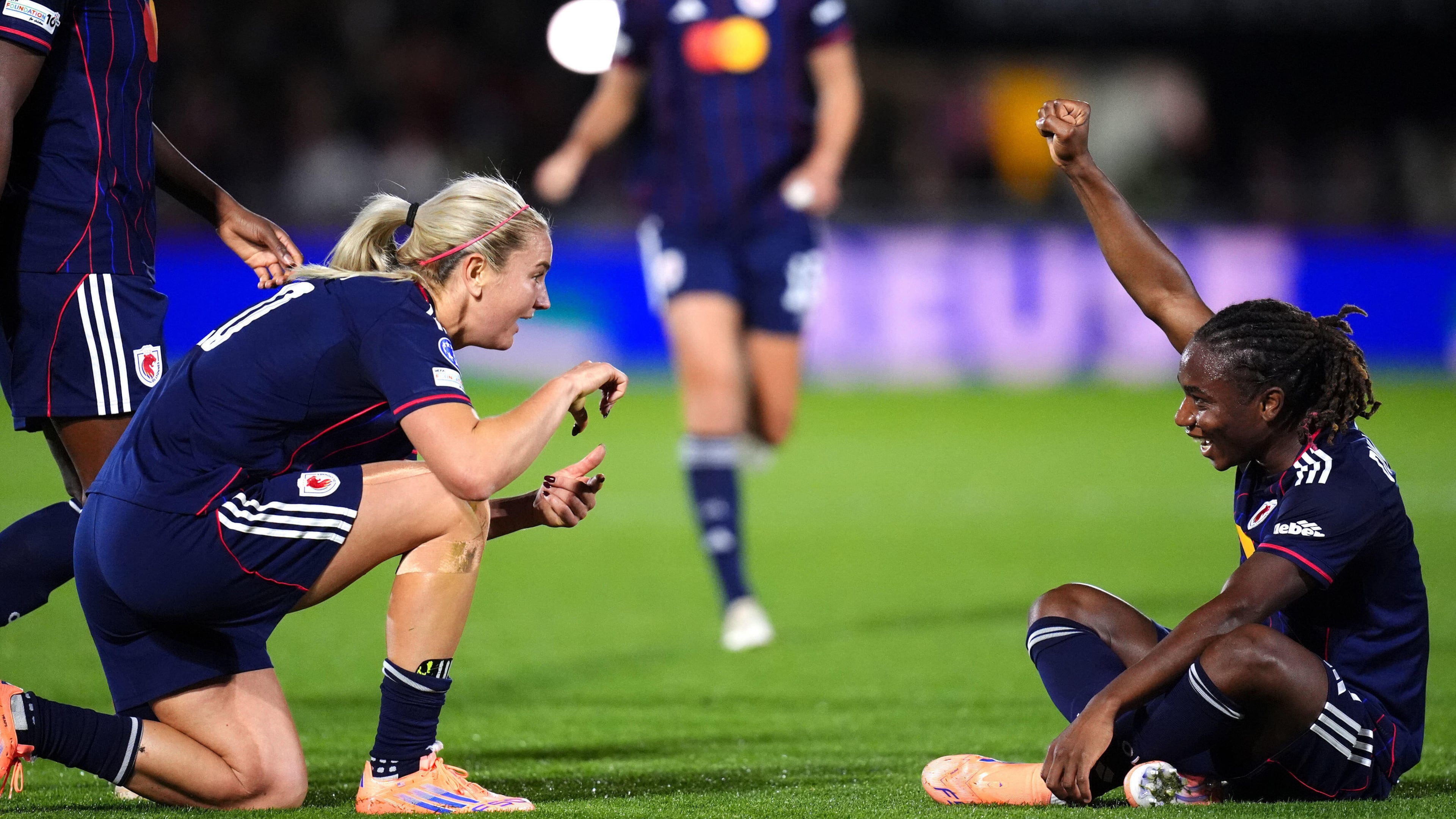 OL Lyonnes' Melchie Dumornay, right, celebrates scoring their side's second goal during the Women's Champions League soccer match between Arsenal and OL Lyonnes at Meadow Park, Borehamwood, England, Tuesday, Oct, 7, 2025. (John Walton/PA via AP)