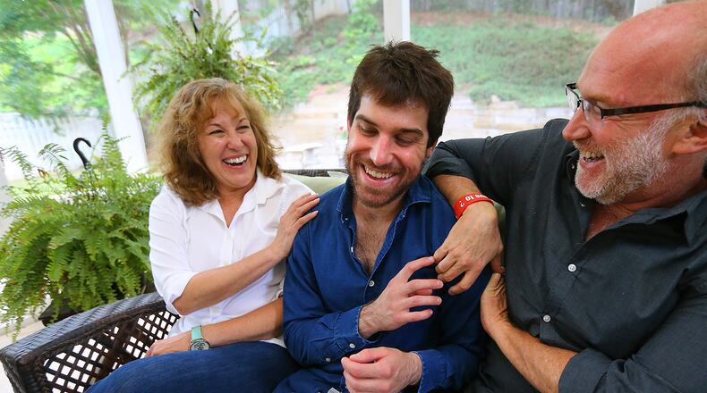 Jeanne and Jeff Schultz enjoy a playful moment with their son Josh on the back porch of the family home after a Sunday meal while he makes a weekend visit, June 7, 2015, in Johns Creek. Curtis Compton / ccompton@ajc.com