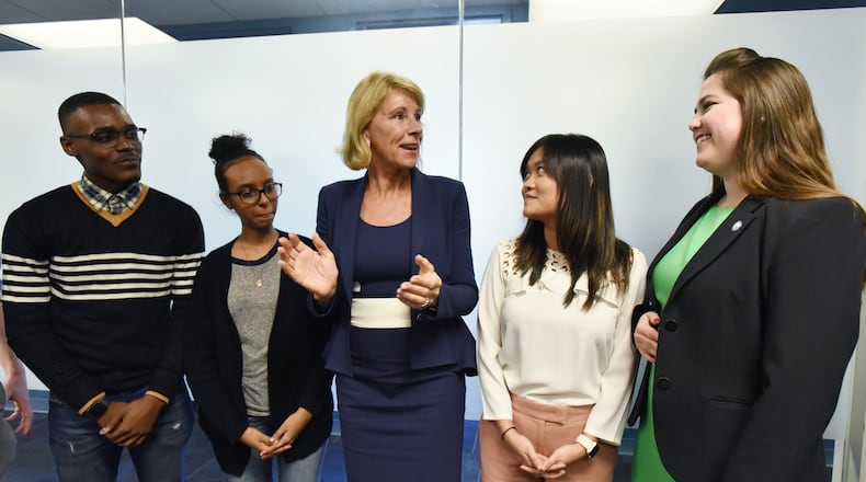 U.S. Secretary of Education Betsy DeVos (center) greets GSU students (from left) Donte Brown, Amila Shake, Jenny Pham and Leila Collins after they took a group photograph during Georgia State University tour and roundtable discussion with students at GSU on Tuesday, Nov. 28, 2017. HYOSUB SHIN / HSHIN@AJC.COM