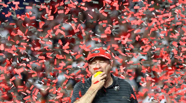 Georgia head coach Kirby Smart takes a bite out of an orange after beating Michigan 34-11 to win the Orange Bowl at Hard Rock Stadium to advance to the national championship game on Friday, Dec. 31, 2021, in Miami Gardens. Curtis Compton / Curtis.Compton@ajc.com